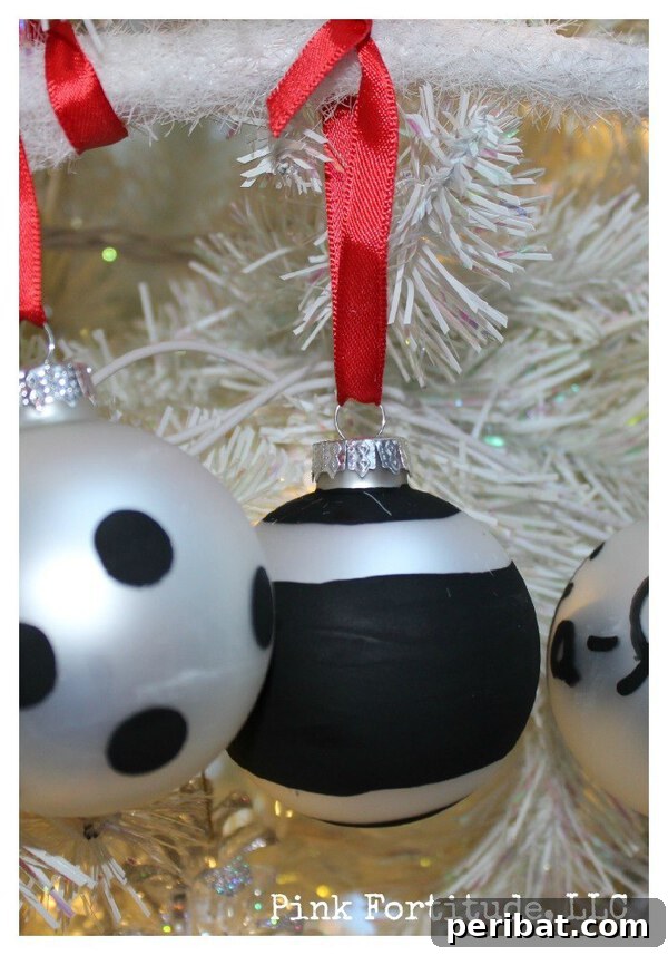 Sixty Sparkling DIY Ornaments for Your Christmas Tree 61 Black and silver ornament in white tree