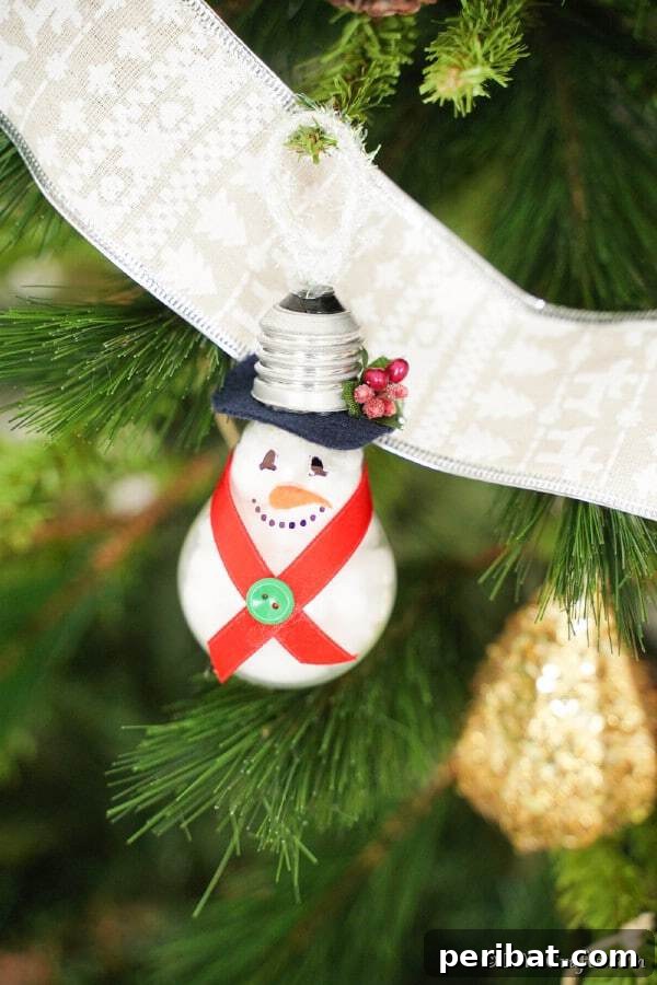Sixty Sparkling DIY Ornaments for Your Christmas Tree 9 Light bulb snowman in tree