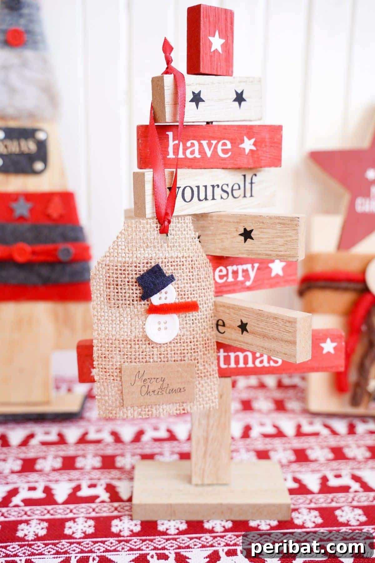 Charming Burlap Christmas Gift Tags: 3 Effortless DIY Styles 28 A snowman burlap gift tag used as holiday decor, set against a red and white checkered table cloth.