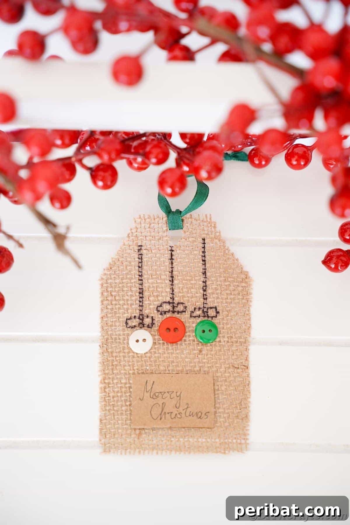 Charming Burlap Christmas Gift Tags: 3 Effortless DIY Styles 8 A charming burlap gift tag adorned with buttons, hanging against a white shiplap wall, adding a rustic decorative touch.
