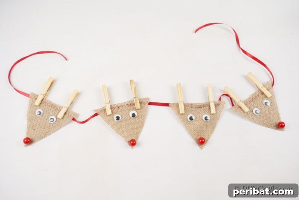 Rustic Reindeer Burlap Garland 11 Multiple burlap reindeer arranged evenly on a piece of festive ribbon