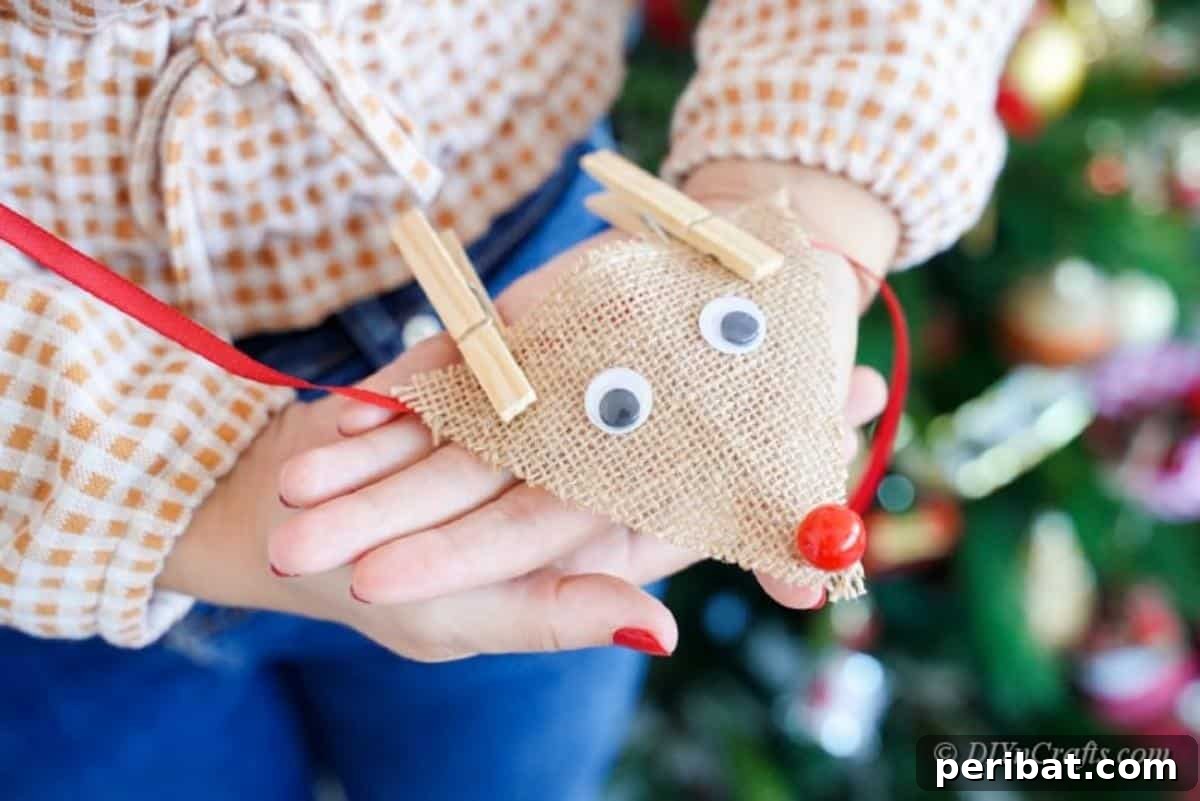 Rustic Reindeer Burlap Garland 18 Woman holding completed burlap reindeer garland with pride