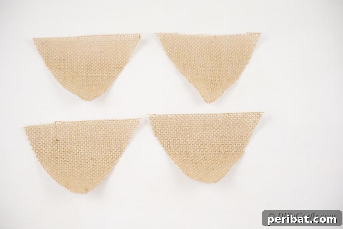 Rustic Reindeer Burlap Garland 8 Neatly cut pieces of burlap triangles on a crafting table