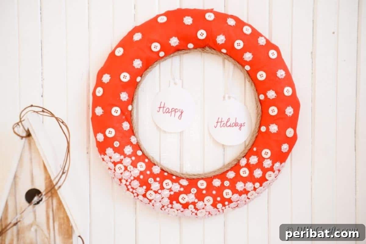 Handmade button wreath hanging on a textured wall as part of holiday decor
