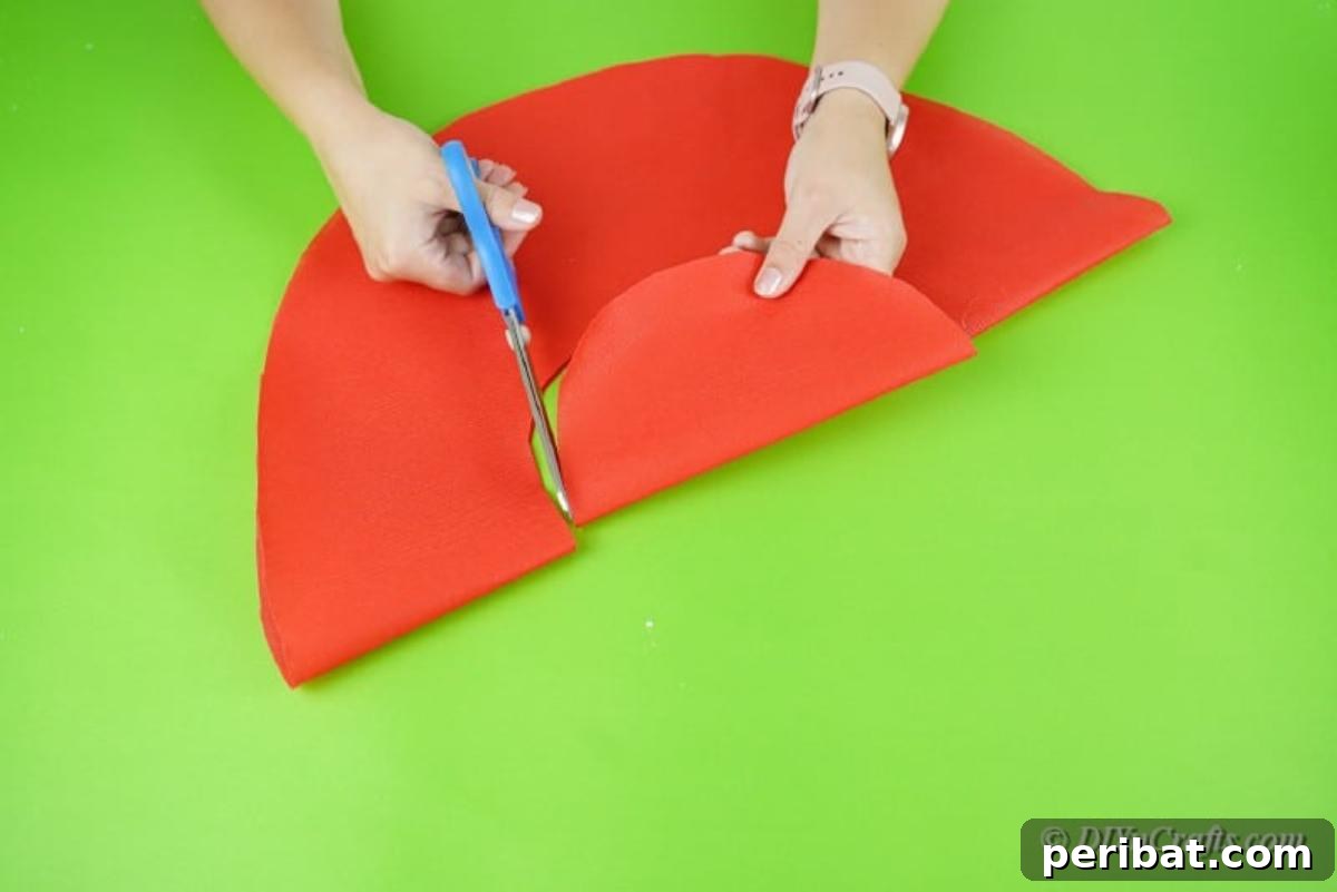 Wrapping paper being cut into a rainbow shape for the wreath