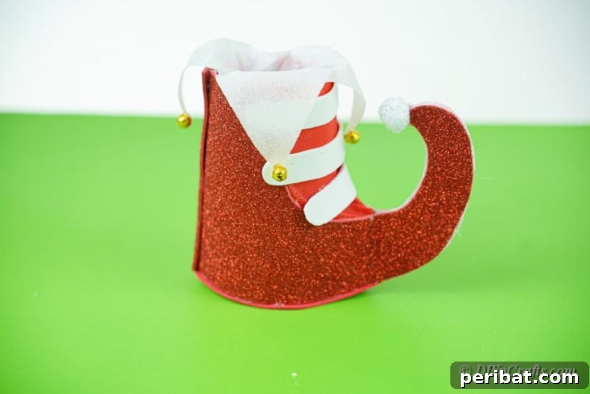 Upcycled Plastic Bottle Santa Boot Decor 17 Completed Christmas boot craft with a white pom-pom on the toe, ready for display