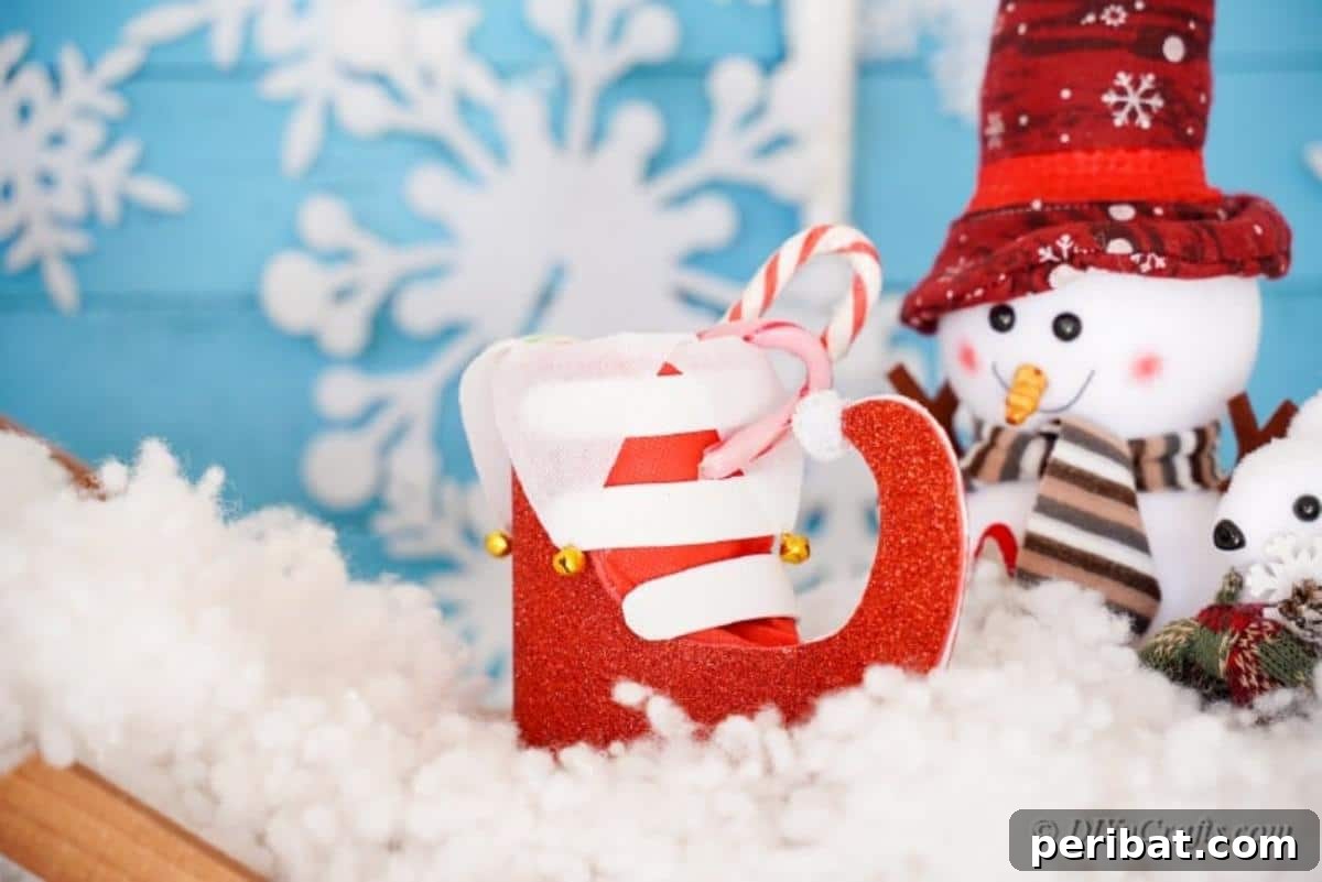 Upcycled Plastic Bottle Santa Boot Decor 19 Santa boot craft resting within a serene Christmas scene, adorned with a delicate snowflake decoration