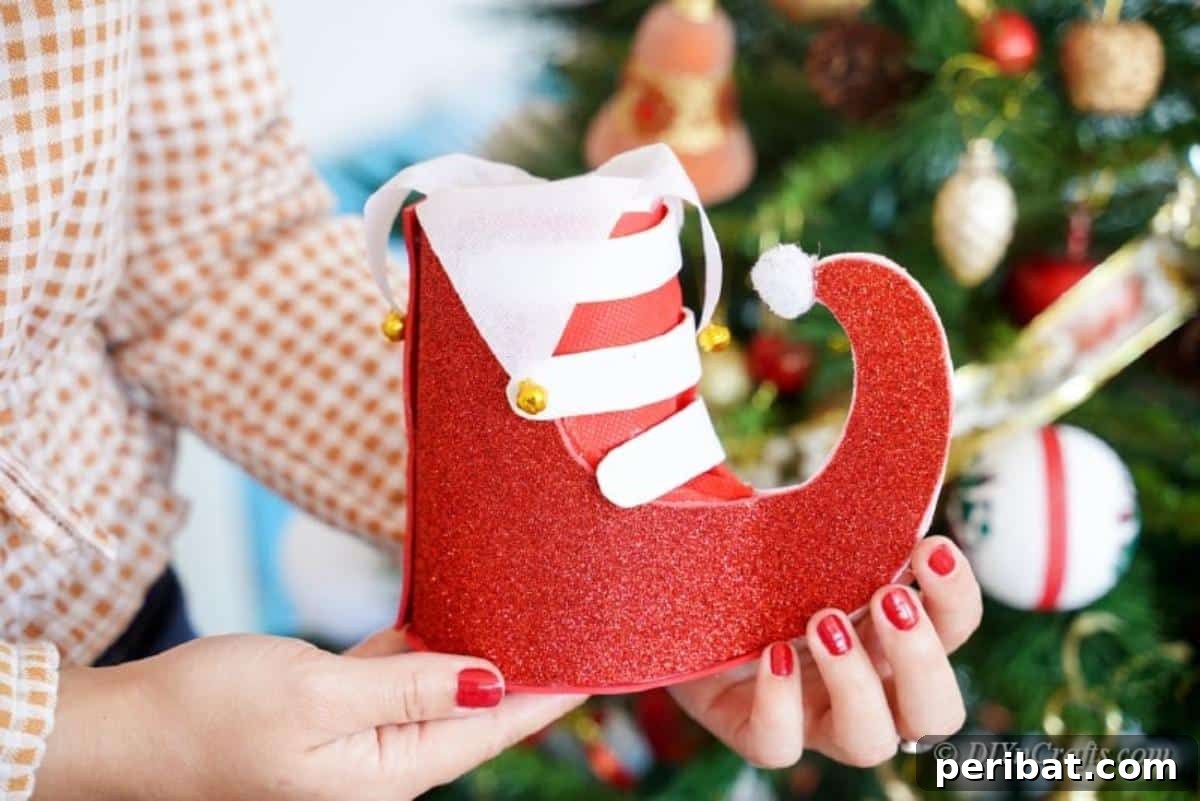 Upcycled Plastic Bottle Santa Boot Decor 20 Woman proudly holding her finished craft Christmas boot decoration, showcasing the successful DIY project