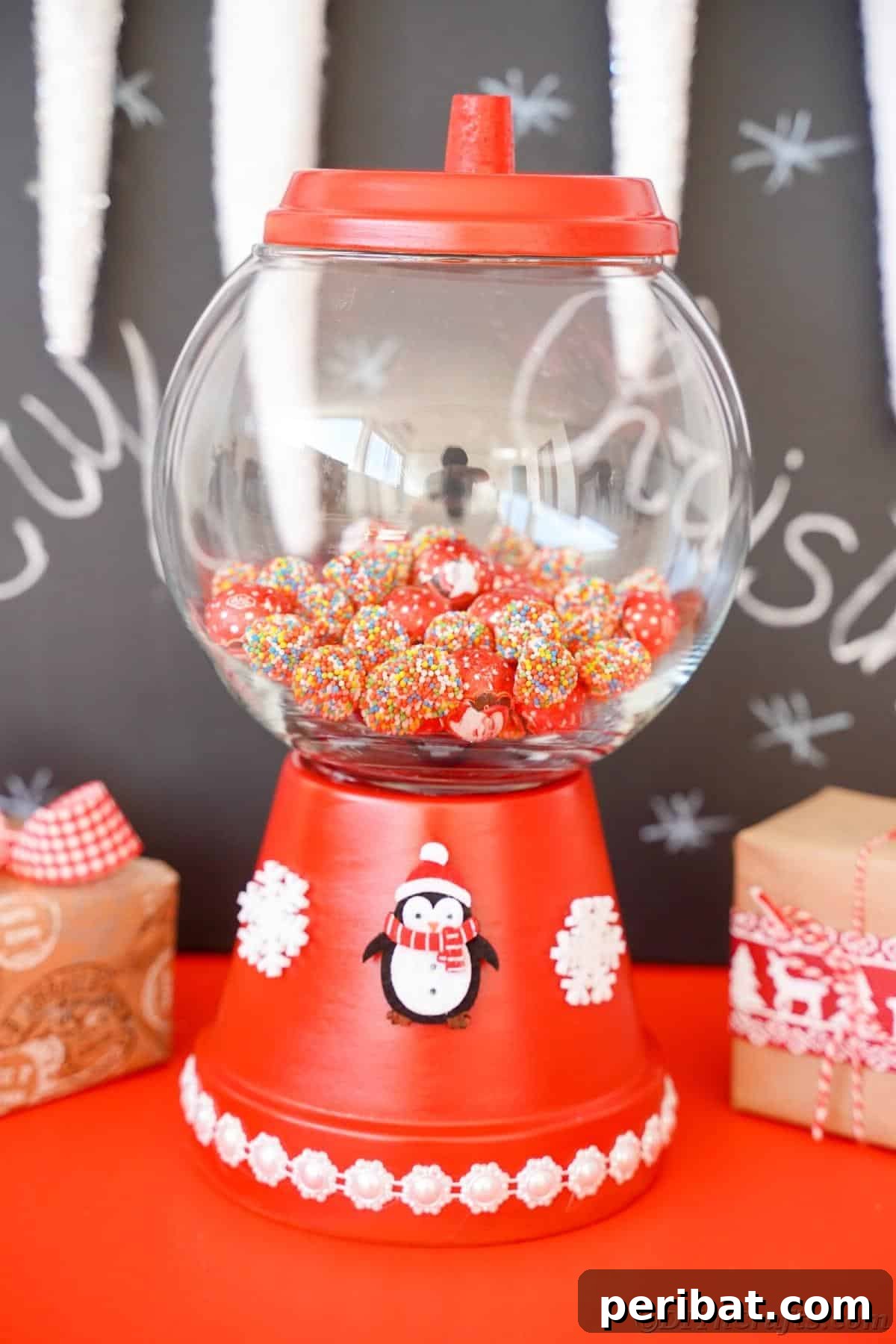 Festive Candy Dispenser on a Budget 4 chalkboard background behind red flower pot candy jar