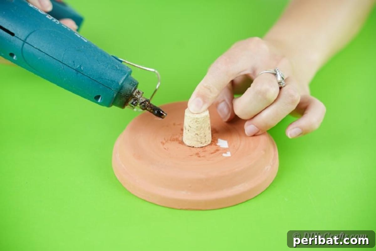 Festive Candy Dispenser on a Budget 9 gluing wine cork to clay pot bottom
