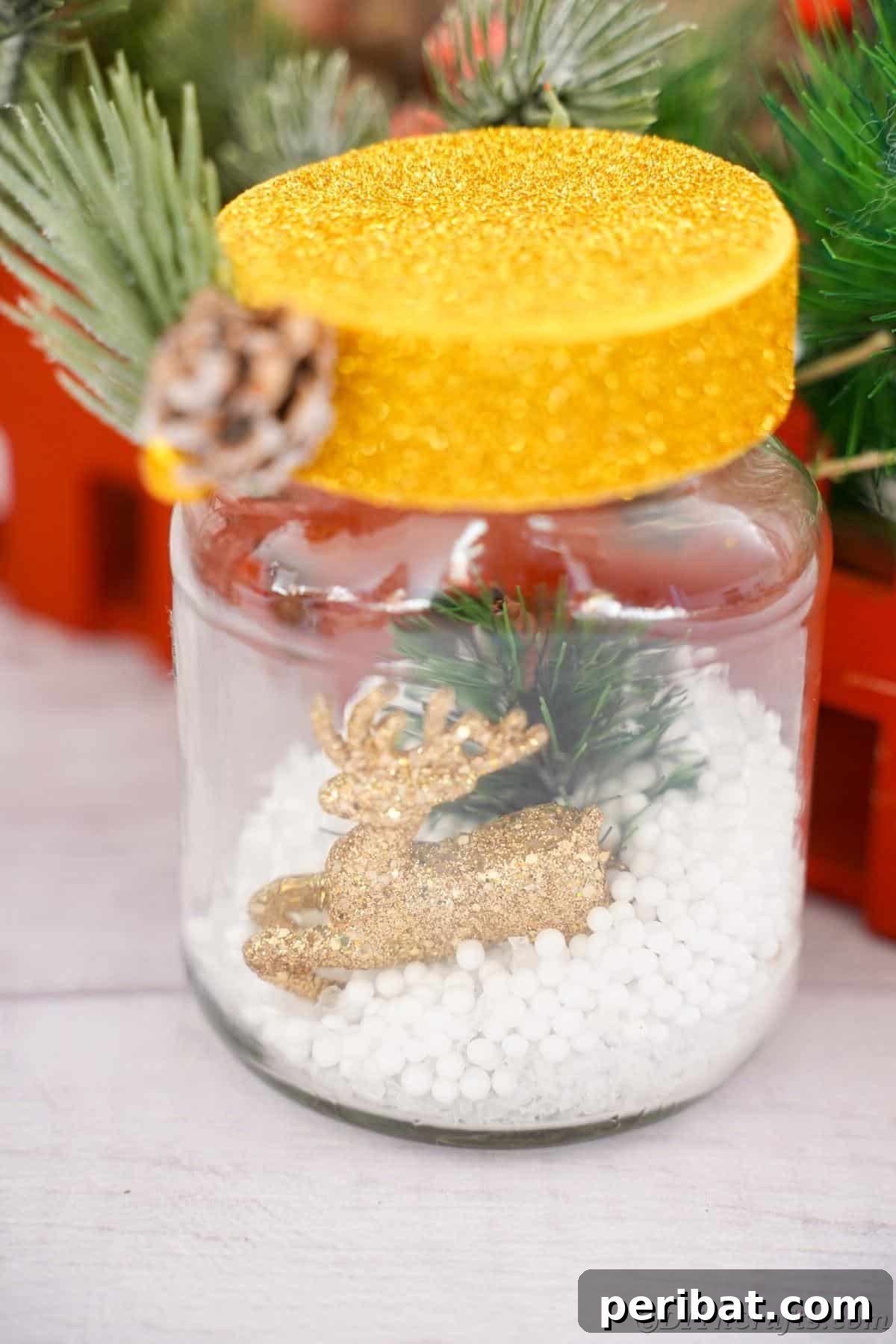 DIY Upcycled Christmas Snow Globe 16 Gold lid on snow globe sitting on tbale