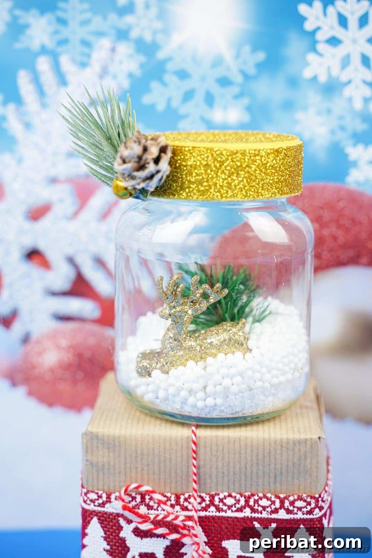 DIY Upcycled Christmas Snow Globe 4 snow globe with yellow cap on top of gift with blue background