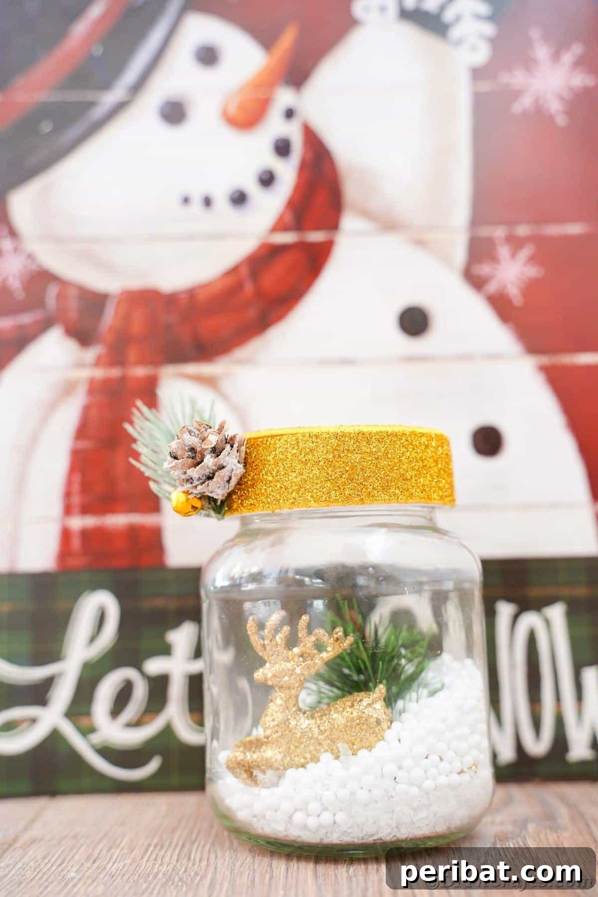 DIY Upcycled Christmas Snow Globe 18 let it snow snowman sign with a small jar with snow and gold cap in front