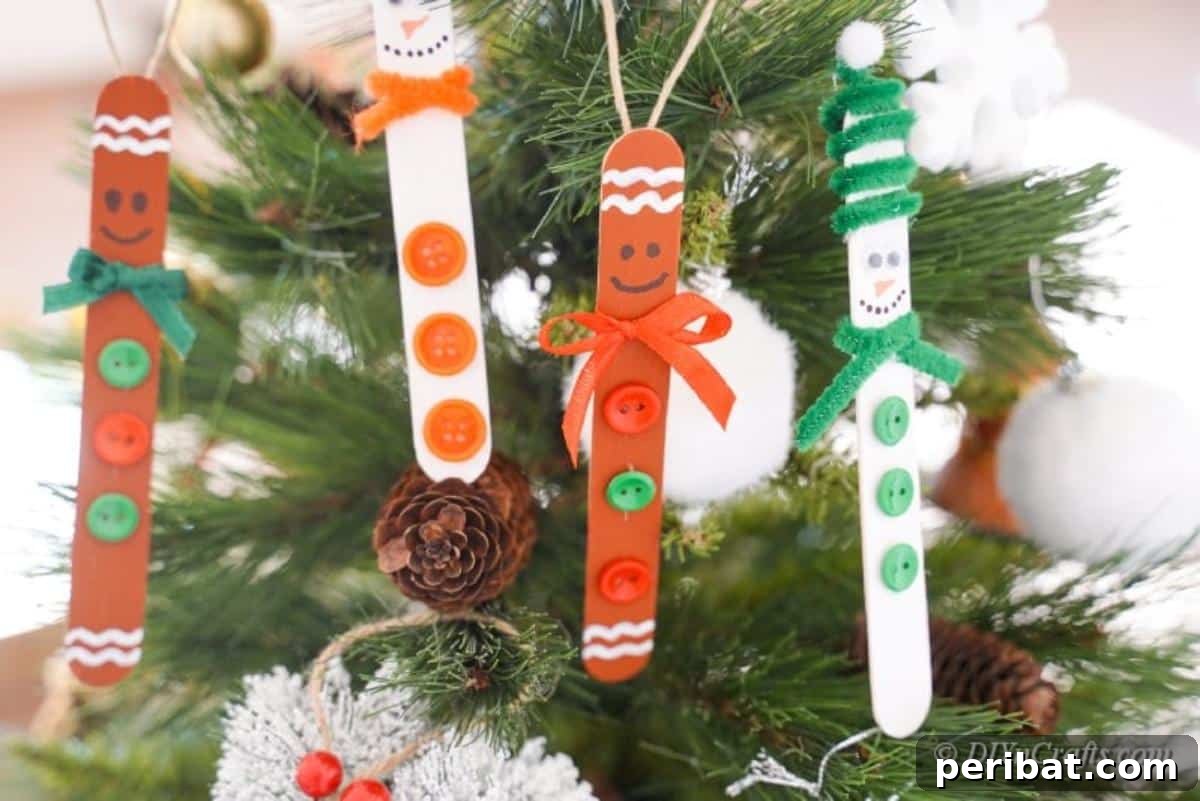 Sweet and Snowy Craft Stick Holiday Decor 16 Finished popsicle stick ornaments hanging from a Christmas tree