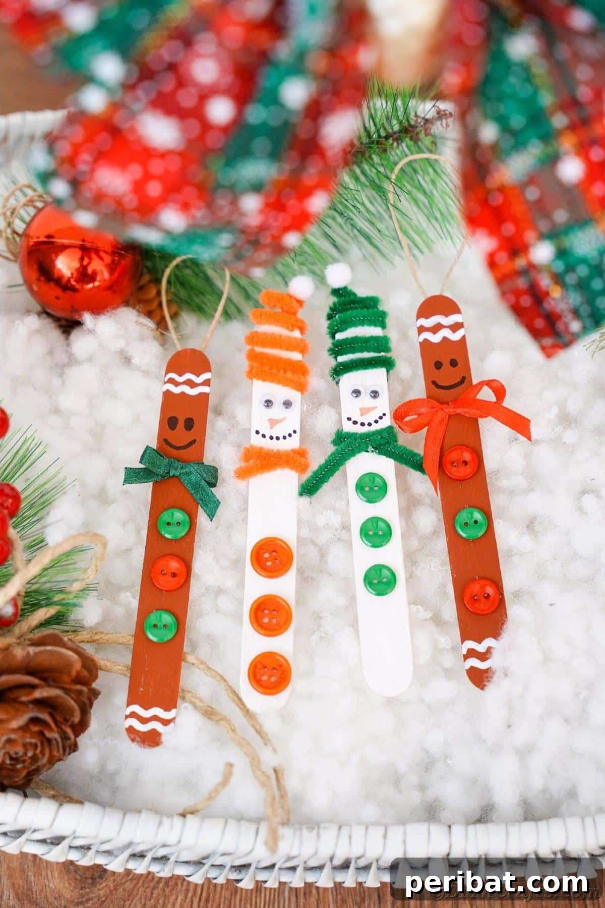Sweet and Snowy Craft Stick Holiday Decor 4 Four finished craft stick ornaments, including snowmen and gingerbread men, arranged on fake snow