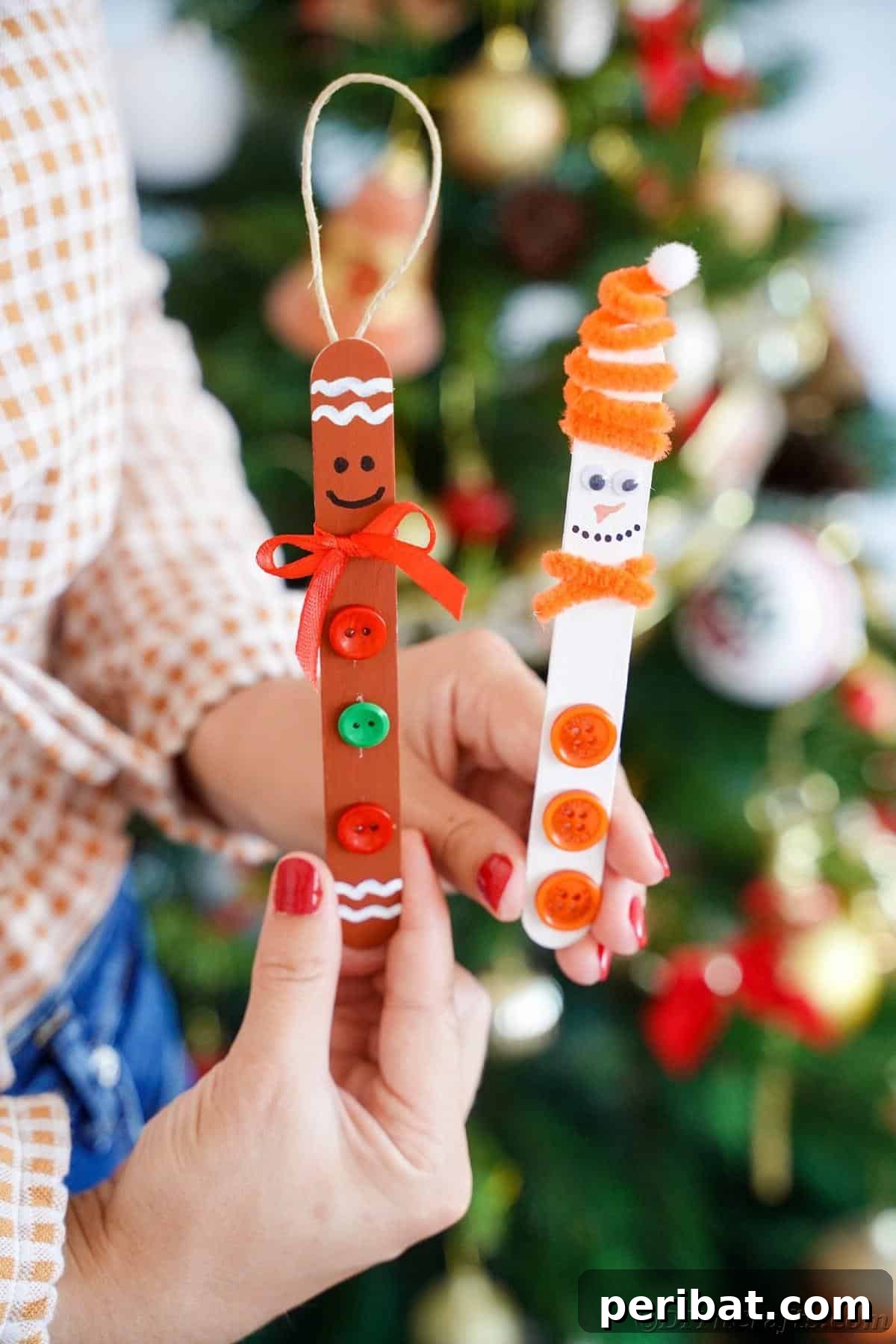 Sweet and Snowy Craft Stick Holiday Decor 28 A woman holding a gingerbread man and a snowman craft stick ornament