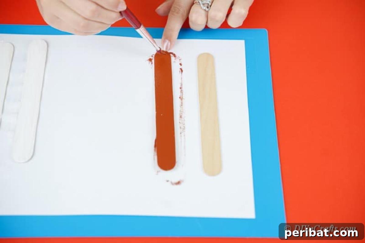 Sweet and Snowy Craft Stick Holiday Decor 9 Painting popsicle sticks white for snowman ornaments