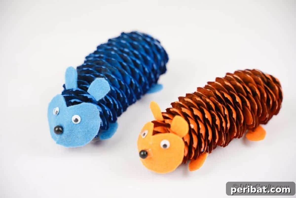Whimsical Pinecone Hedgehogs 14 Two completed pinecone hedgehog crafts, one blue and one orange, showcasing their googly eyes and felt features, ready for display.