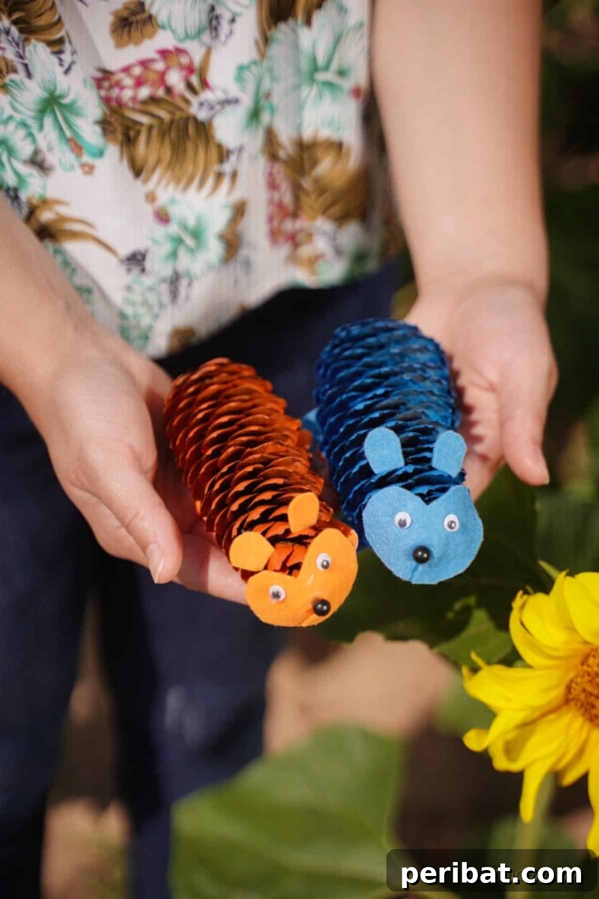 Whimsical Pinecone Hedgehogs 3 A woman's hands gently holding two handmade natural pinecone hedgehog crafts, highlighting their delicate features and the joy of DIY.
