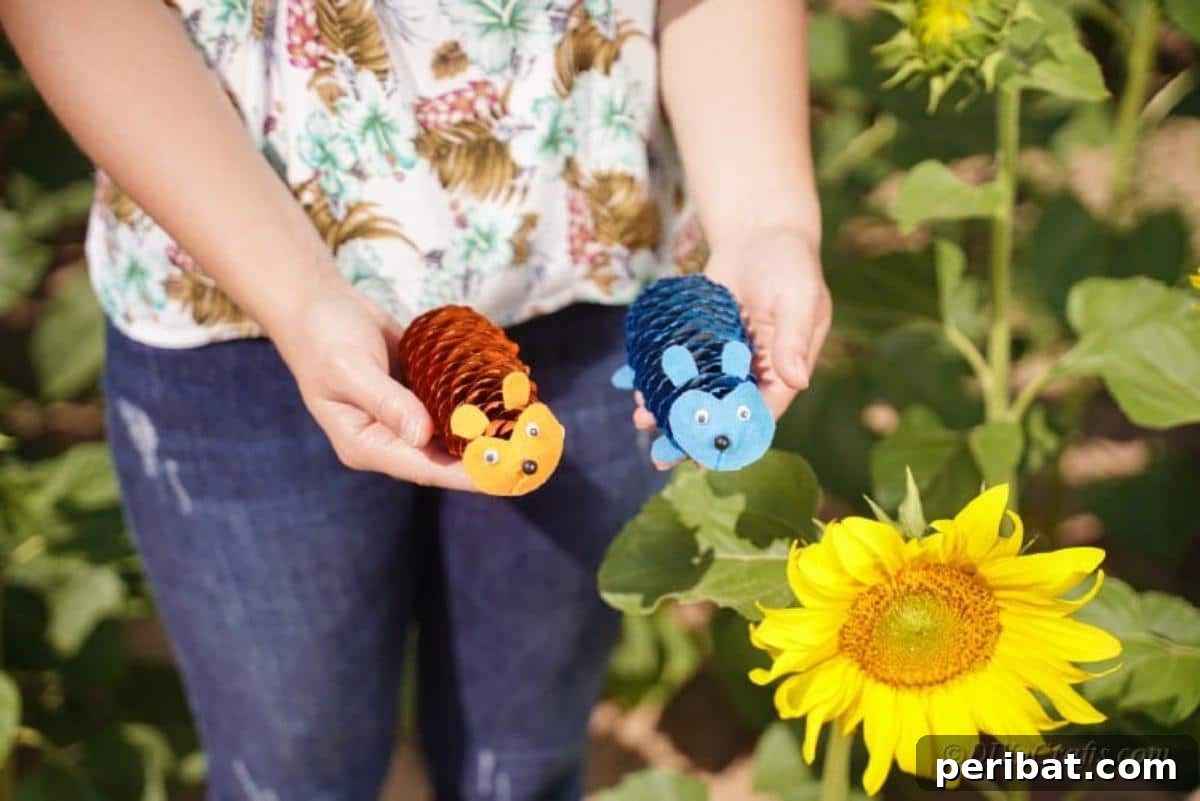 Whimsical Pinecone Hedgehogs 15 A woman in a floral shirt gently holding two completed pinecone hedgehogs, one blue and one orange, showcasing the final craft.