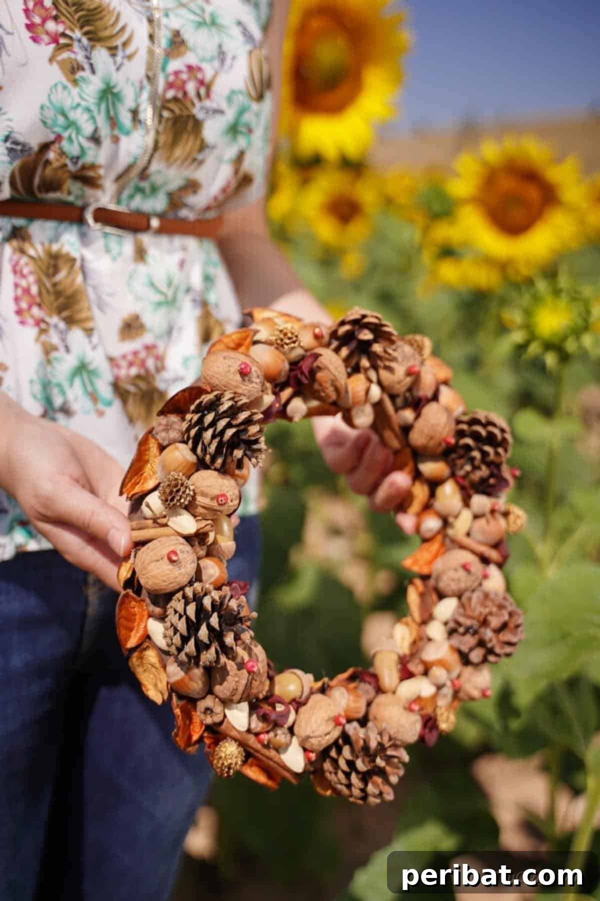 Foraged Fall Wreath 15 woman holding natural wreath in sunflower field