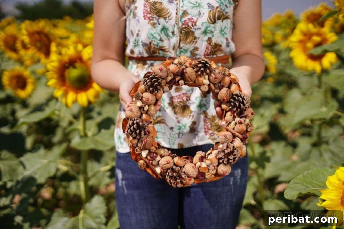 Foraged Fall Wreath 14 woman holding wreath in sunflower field