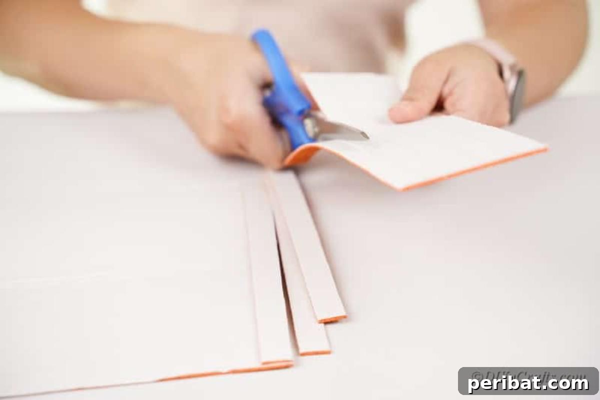 Cutting an orange foam craft sheet into strips.