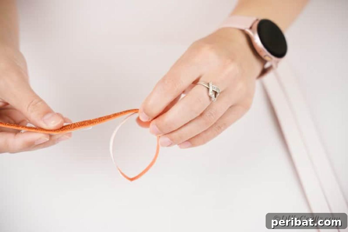 Combining an orange foam craft sheet strip with a cut-up toilet paper roll ring.