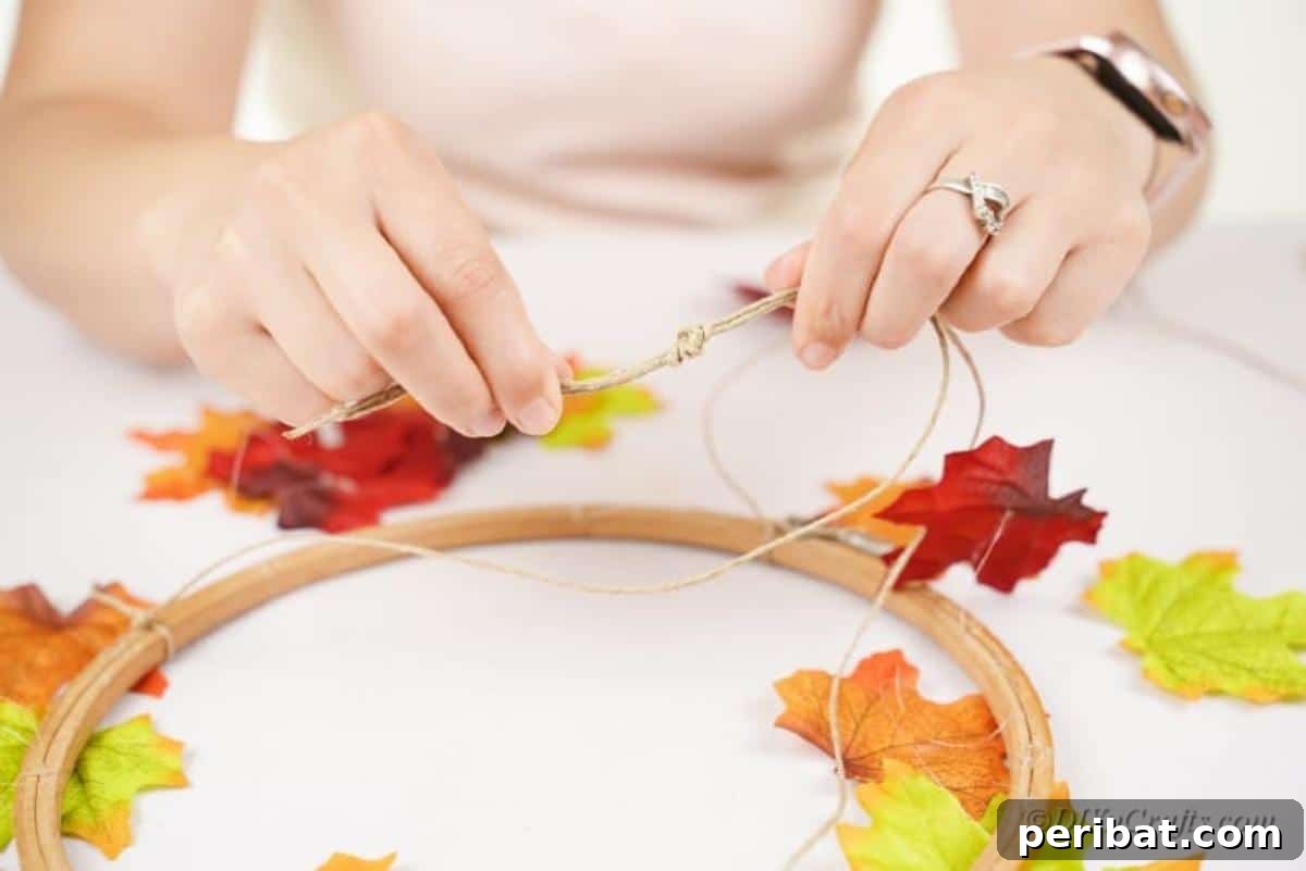 Vibrant Autumn Leaves Mobile 13 Adding fake leaves to craft hook woman hands