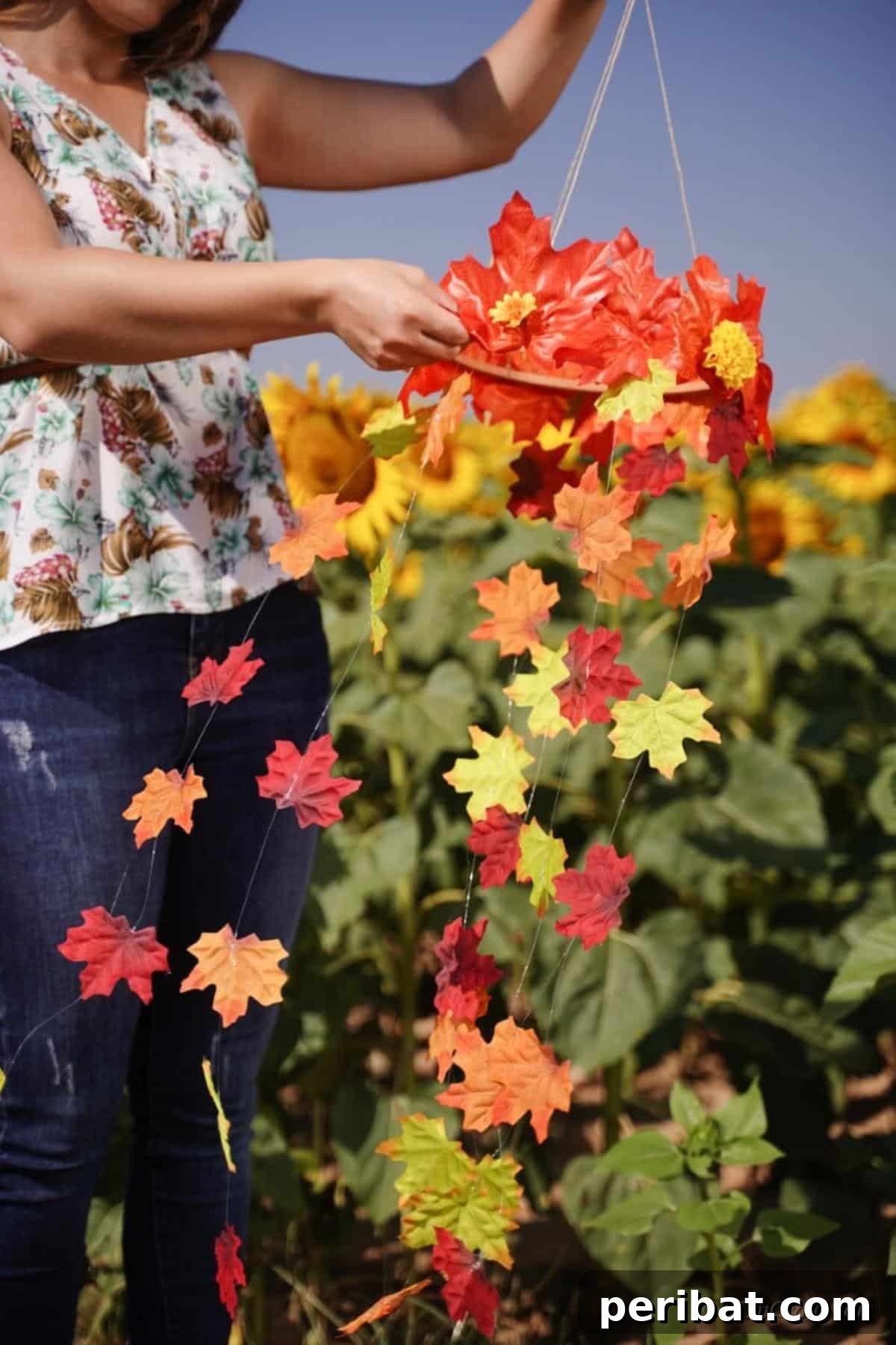 Vibrant Autumn Leaves Mobile 17 Woman holding mobile next to sunflower field