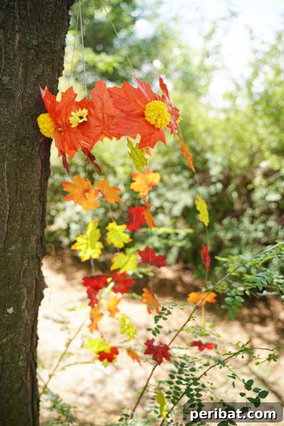 Vibrant Autumn Leaves Mobile 18 Mobile with fake leaves hanging against tree