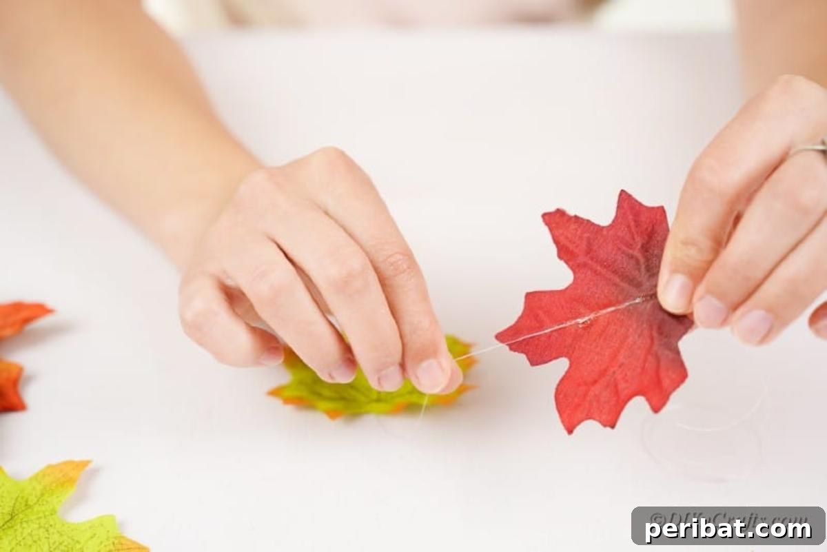 Vibrant Autumn Leaves Mobile 7 stringing fake leaves onto thread
