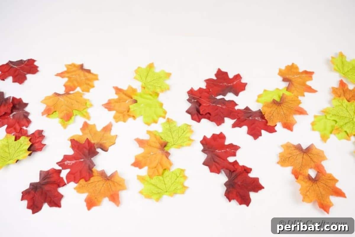 Vibrant Autumn Leaves Mobile 8 Strings of fake leaves laying on white table