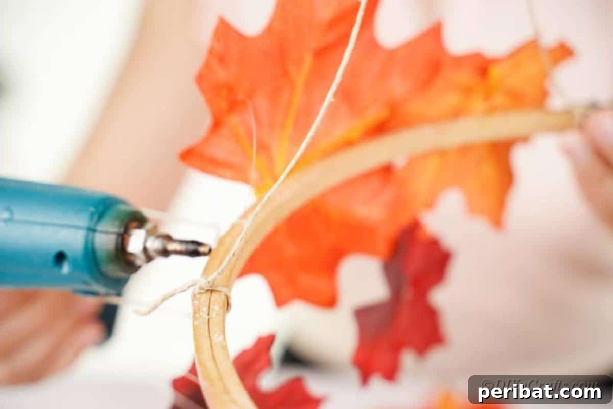 Vibrant Autumn Leaves Mobile 9 hot glue gun on craft hoop with leaves