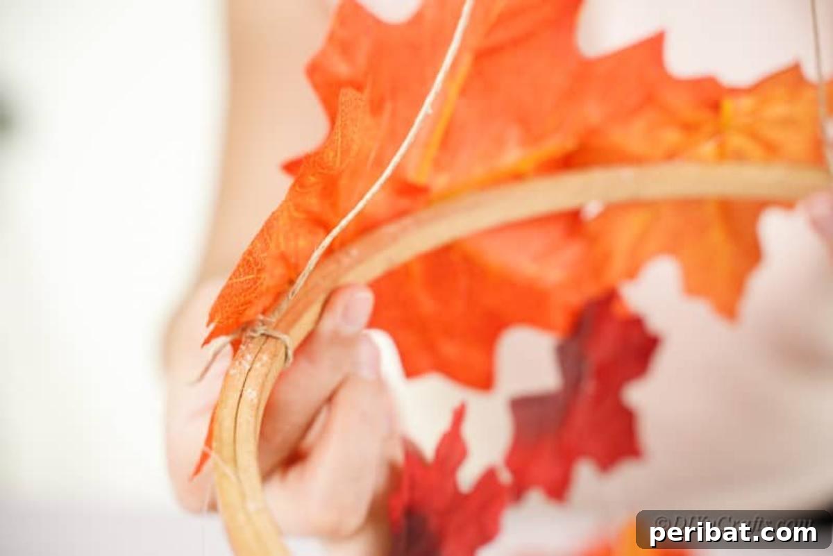 Vibrant Autumn Leaves Mobile 10 Twine glued onto embroidery hoop next to orange leaf