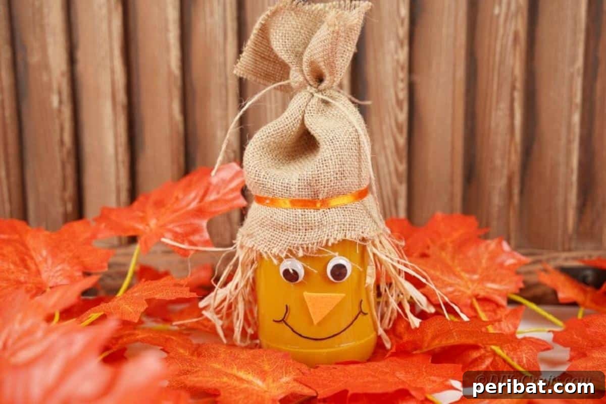 Whimsical Fall Scarecrow Jar Craft 17 A beautifully crafted scarecrow jar, complete with burlap hat, straw hair, and an orange body, displayed on a decorative autumn spread.