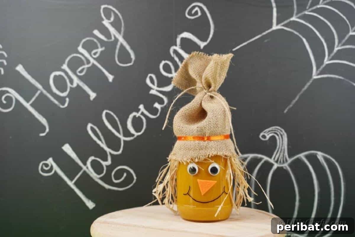 Whimsical Fall Scarecrow Jar Craft 19 A completed scarecrow jar craft, featuring a rustic burlap hat, straw hair, cheerful facial features, and an orange-painted body, perfect for fall decor.