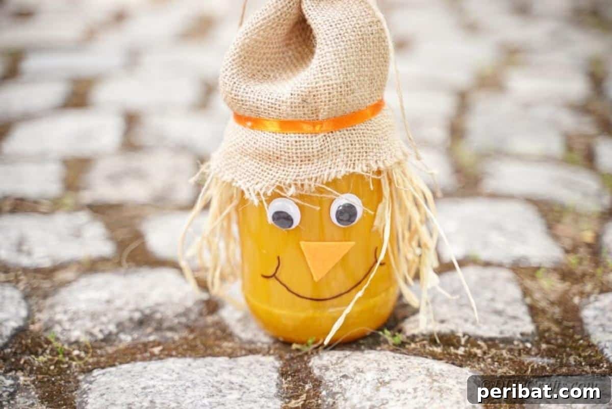 Whimsical Fall Scarecrow Jar Craft 5 A charming DIY scarecrow jar craft with burlap hat and straw hair, standing proudly on the ground as outdoor fall decoration.