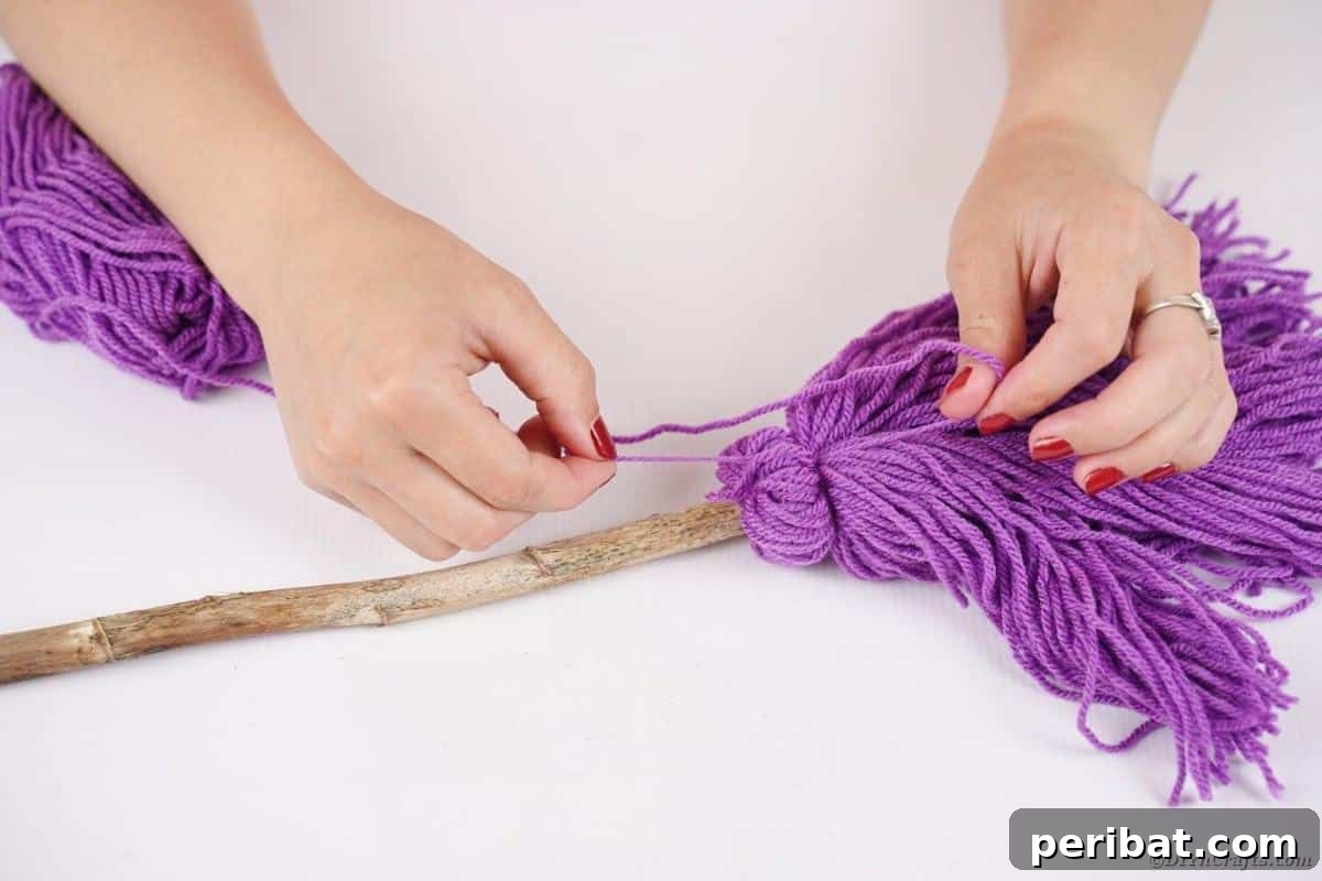 Bewitching DIY Broomstick Decor 11 Attaching yarn to broom