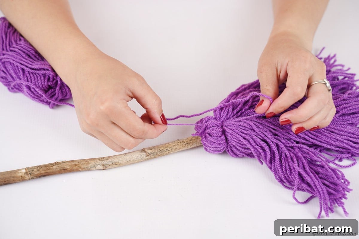 Bewitching DIY Broomstick Decor 17 Attaching yarn to broom