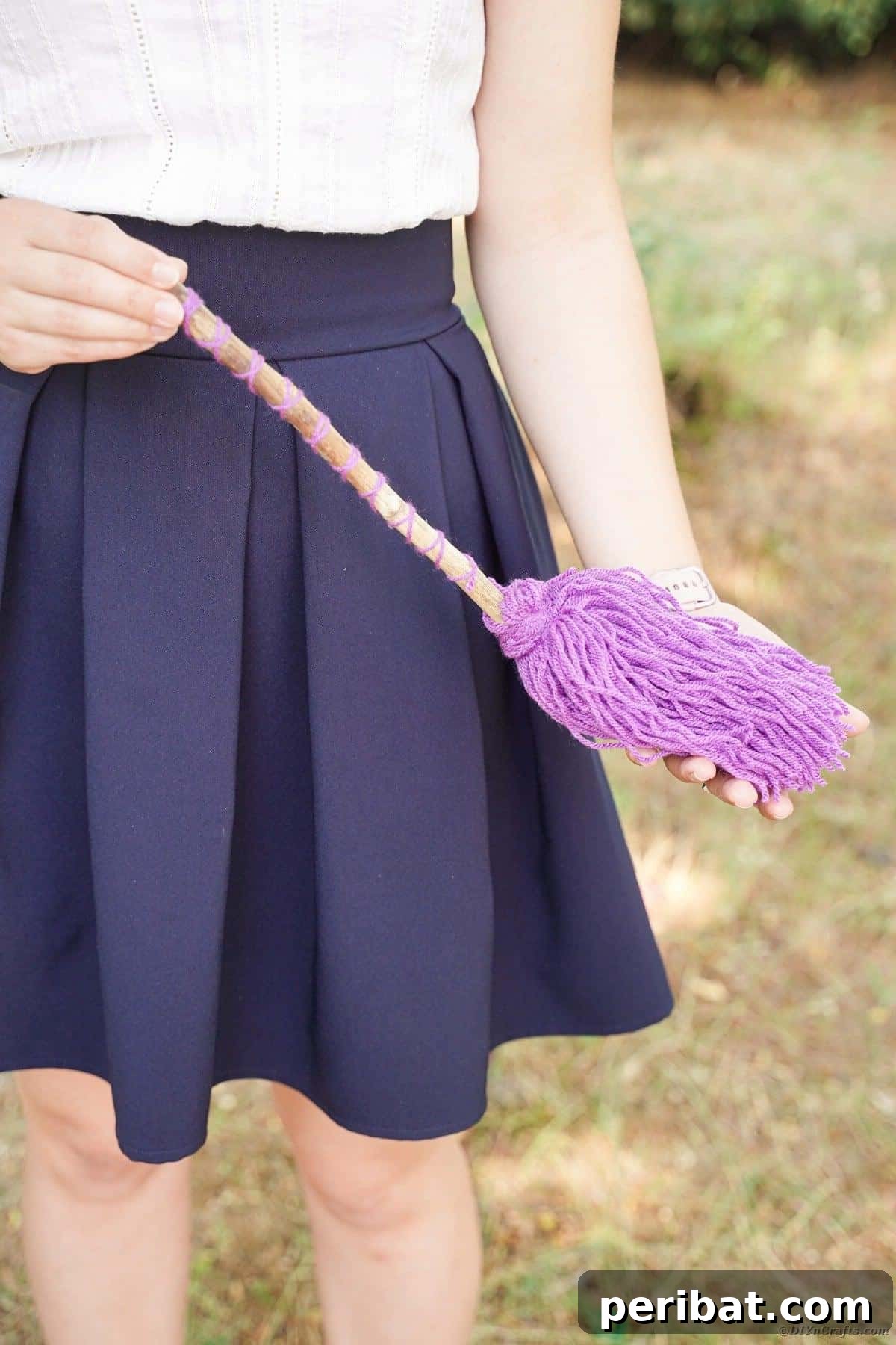 Bewitching DIY Broomstick Decor 22 Woman holding witch's broom