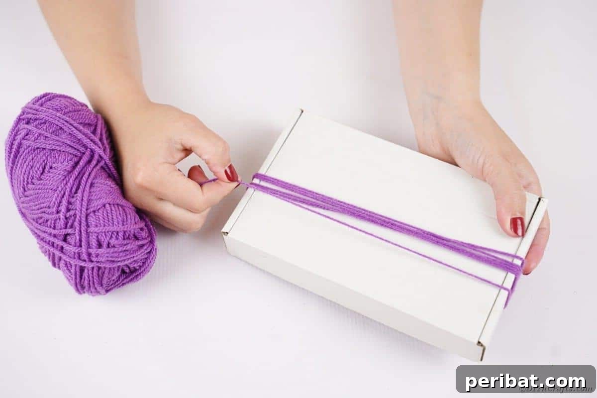 Bewitching DIY Broomstick Decor 8 Wrapping yarn around box