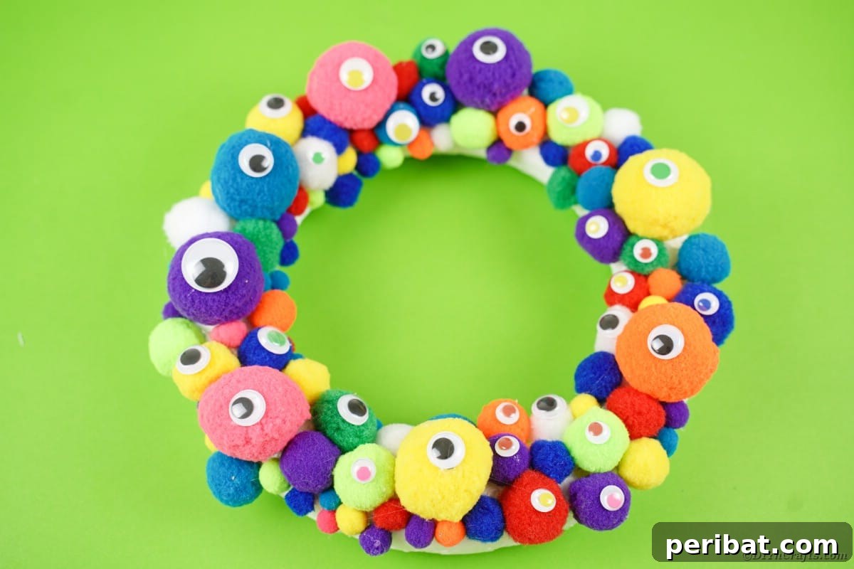 Creepy Cute Pom Pom Monster Wreath 8 Monster wreath on green surface