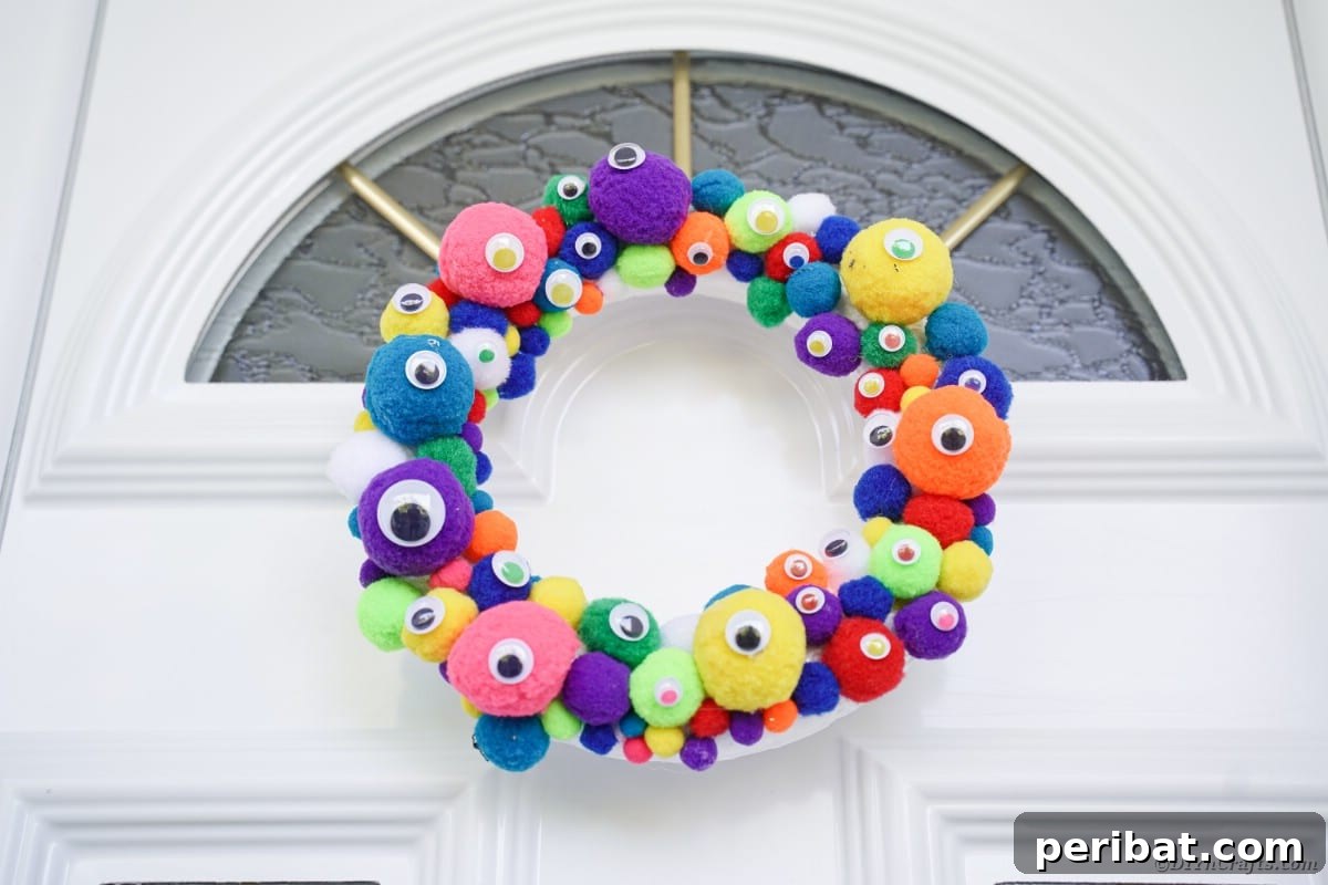 Creepy Cute Pom Pom Monster Wreath 10 Colorful monster eye wreath on white front door