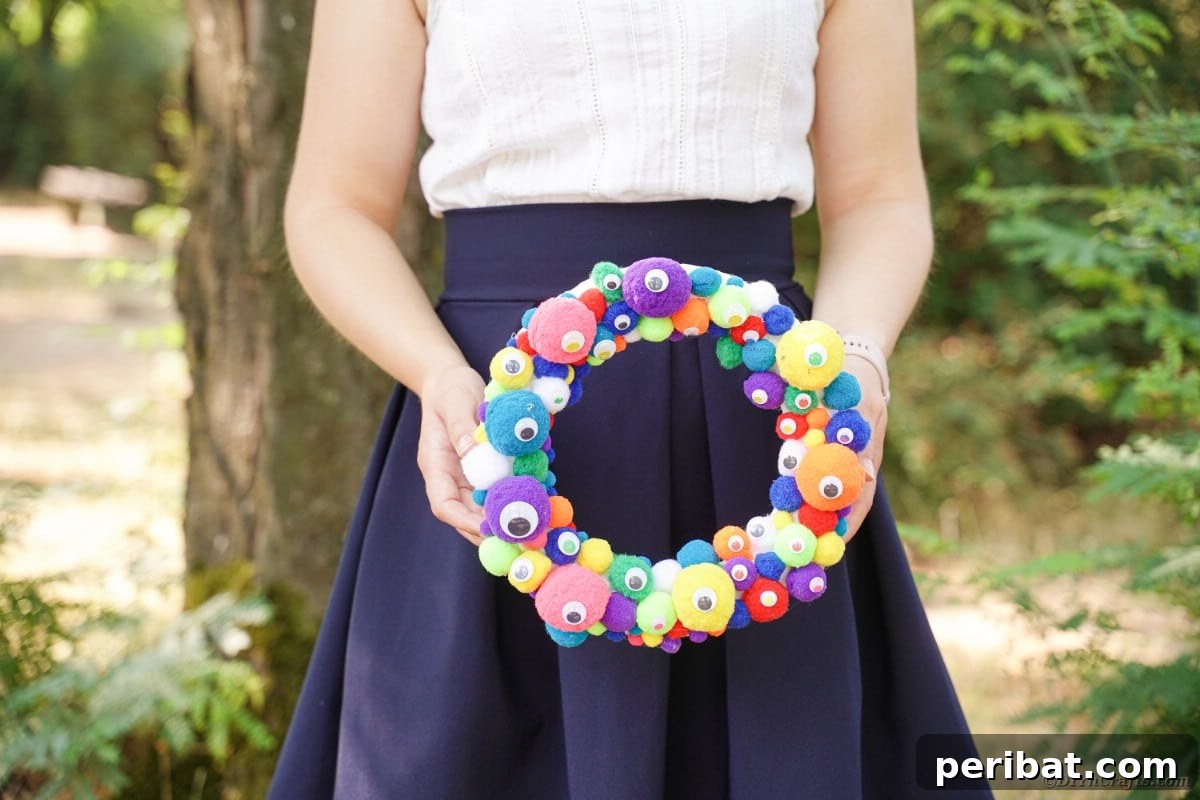 Creepy Cute Pom Pom Monster Wreath 11 Woman holding monster eye wreath