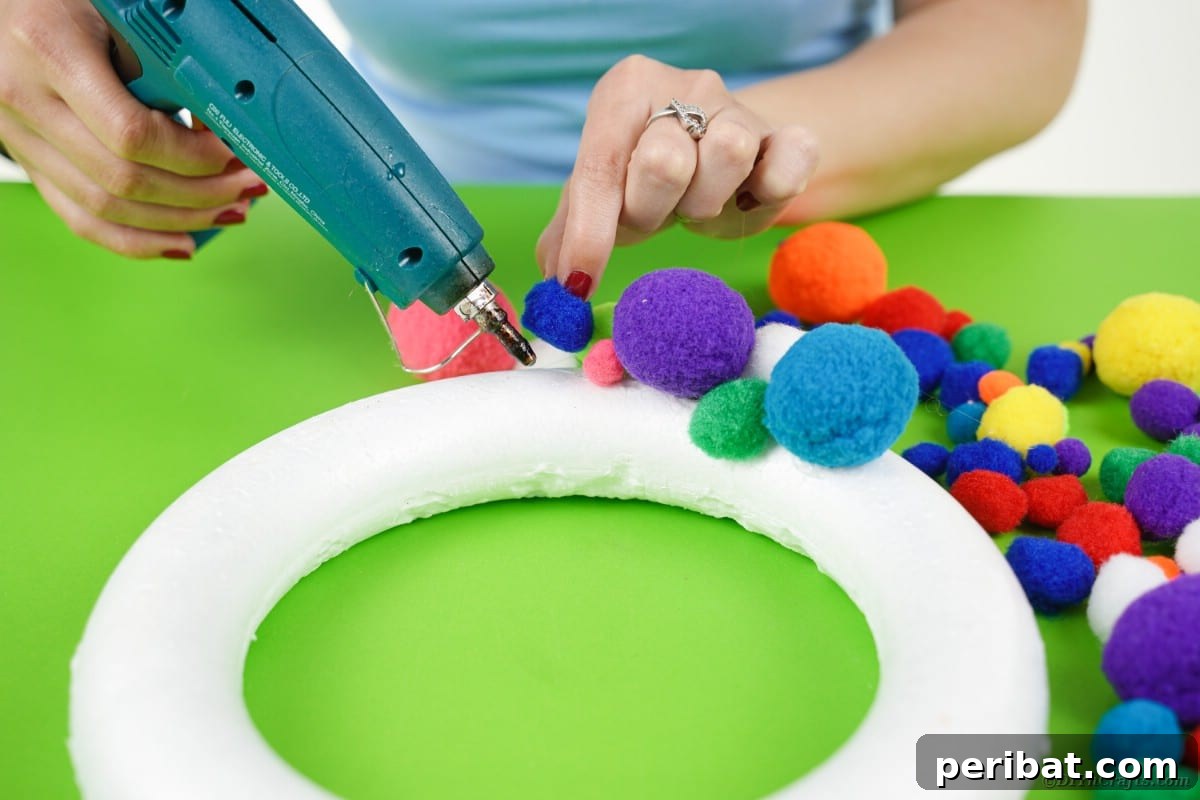 Creepy Cute Pom Pom Monster Wreath 5 Gluing pom poms to wreath form