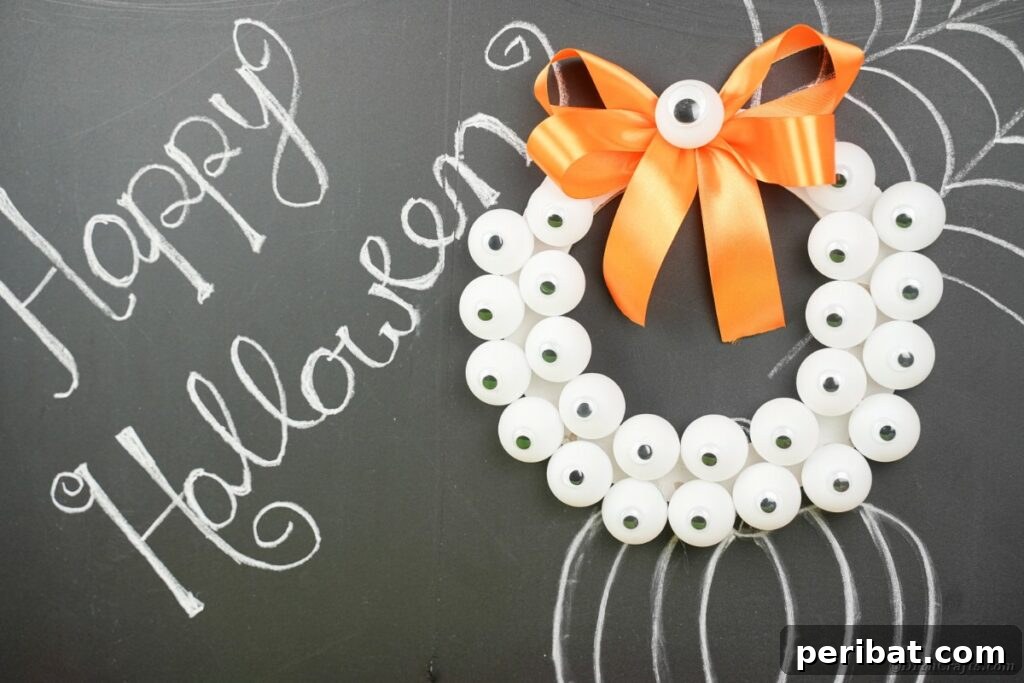 Ghoul's Eye Halloween Entry Wreath 4 A monster eyeball wreath with a unique, spooky texture, leaning against a rustic chalkboard background