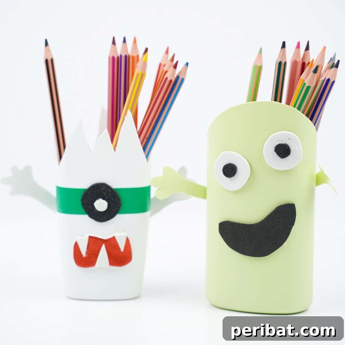 Monster pencil holders on white surface