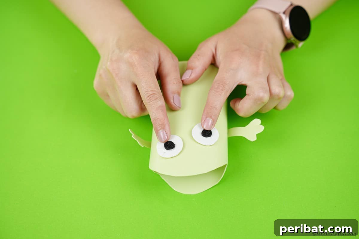 Gluing eyes on green monster 
