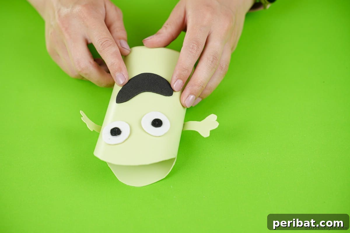 Gluing mouth on green bottle